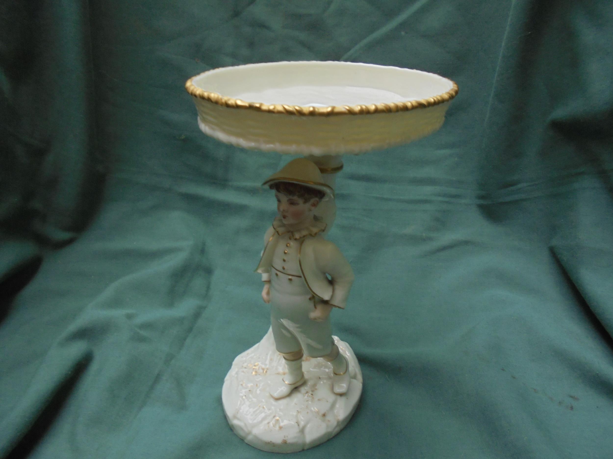 Worcester lustre figure of boy with sweet dish above on tree shaped stand