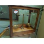 Complete set of weighing scales in 4 sided glass case with box of weights