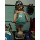 Large pottery figure of young girl on stand,