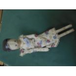 Early wooden peg doll with painted face and original dress