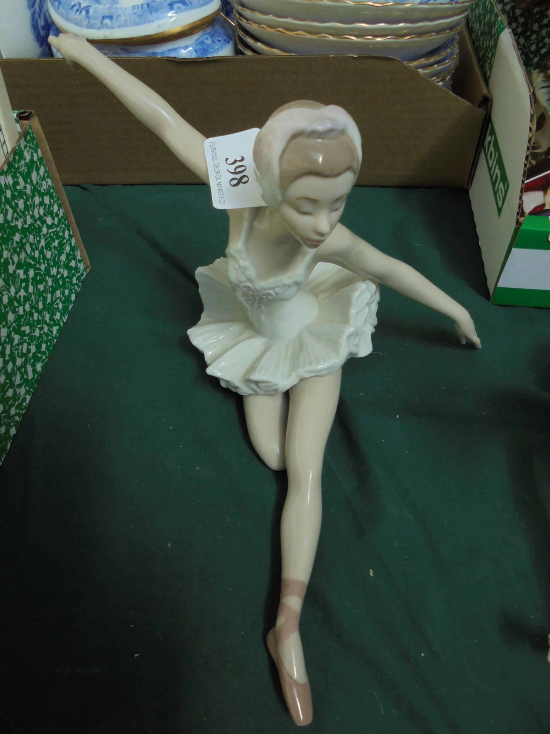 Porcelain figurine of a ballerina with arms out