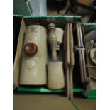 Box of kitchen treen including potato mashers, tie press and hot water bottle marked W.