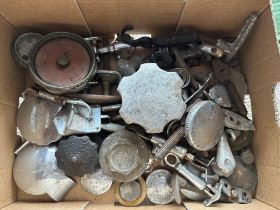 A box of vintage car spares to include fuel caps, bonnet catches, door handles etc.