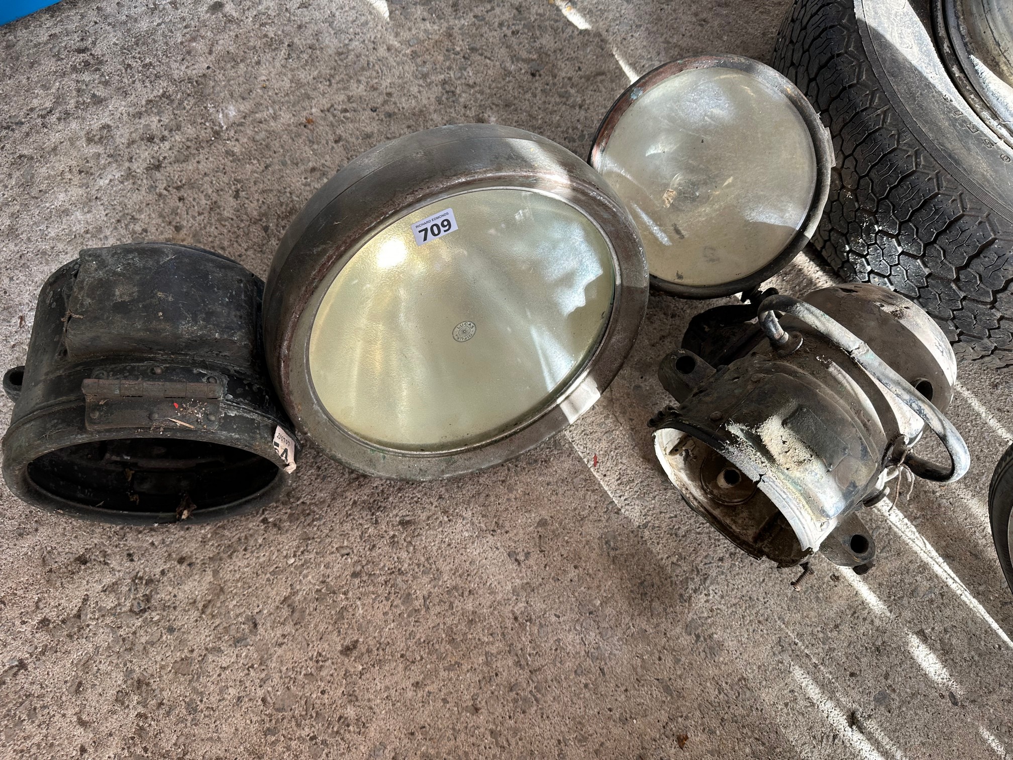 Four early headlamps including a Lucas King of The Road bell lamp.