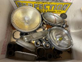 An autojumbler's lot to include lamps, spares, Alvis parts, mudguard bar etc.