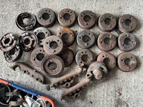 A large assortment of Austin 7 spares to include brake drums, manifolds etc.