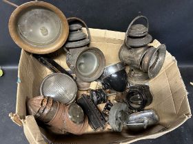 An autojumbler's lot of assorted car lamps.