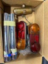 An autojumbler's lot of two Mini tail lamps, a Monaco car badge, three VW Beetle NOS tail pipes etc.