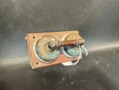 A twin ignition switch on wooden back board.