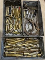 Three trays of brass grease guns.