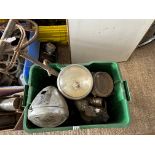 An assortment of early acetylene lamps including an early motorcycle and stirrup pump.