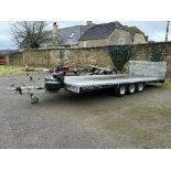 A Brian James triple axle tilt bed car transporter with winch attached