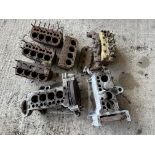 A quantity of blocks, two lower half of engines, one with a sump, a cylinder head with block etc.