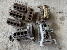 A quantity of blocks, two lower half of engines, one with a sump, a cylinder head with block etc.