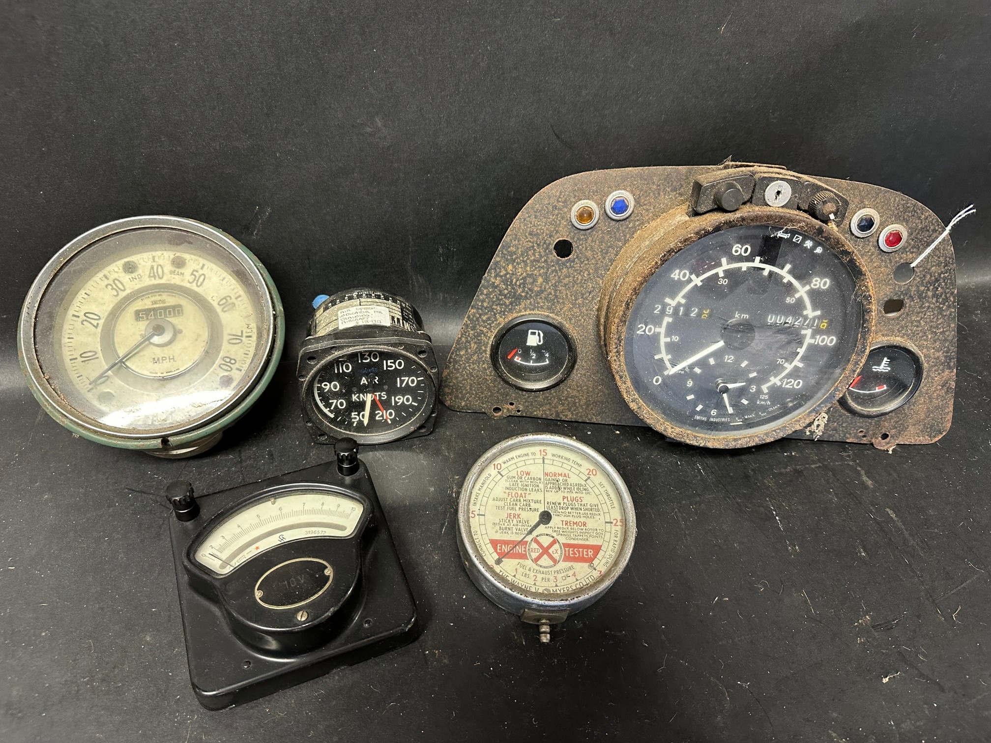A Smiths tacho, an aero gauge, a Smiths speedometer, a Redex engine tester and a volt meter.