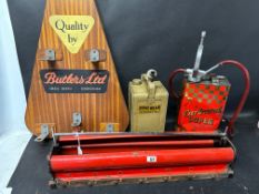 A Butlers Ltd. display stand for spotlights, an Esso Blue Paraffin can. a Carburol can with