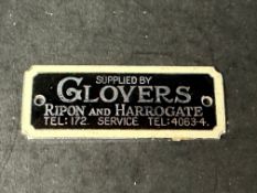 An enamel supplier dashboard plaque, badge, emblem for Glovers of Ripon and Harrogate, made by J.