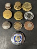 A selection of brass wheel hubs, radiator caps, oil caps and a Ford tax disc holder inc. Castrol,