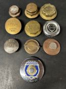 A selection of brass wheel hubs, radiator caps, oil caps and a Ford tax disc holder inc. Castrol,