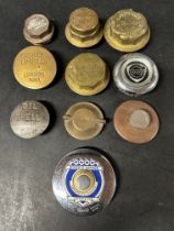 A selection of brass wheel hubs, radiator caps, oil caps and a Ford tax disc holder inc. Castrol,