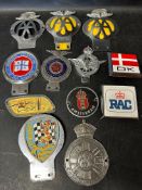 A quantity of assorted car badges.