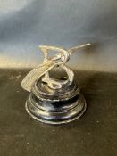 A Bentley winged B car accessory mascot mounted on turned wooden display base.