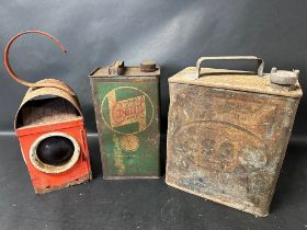 An Esso two gallon can with plain cap, a road lamp and a Wakefield Castrol Motor Oil gallon can.