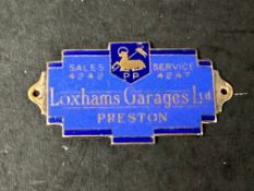 An enamel supplier dashboard plaque, badge, emblem for Loxhams Garages Lts. Preston, made by J.