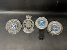 Four RAC car badges.