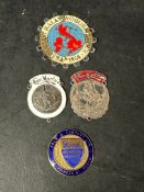 Three enamel supplier dashboard plaques, badges, emblems and a Vespa rally plaque. One for Ford,