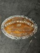 An enamel supplier dashboard plaque, badge, emblem for Ernest Whatfield Ltd. Sheffield.