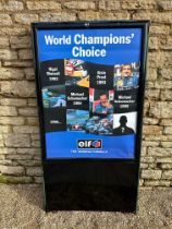 A garage forecourt Elf related advertising stand with poster showing Formula 1 racing drivers