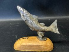 A circa 1930 Desmo leaping salmon car accessory mascot mounted to wooden base.