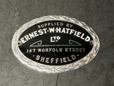 An enamel dashboard plaque for Ernest Whatfield Ltd. of Sheffield.