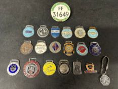 A collection of enamel key fobs, a bus conductor's badge and an MG keychain (20).
