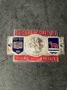 An enamel supplier dashboard plaque, badge, emblem for Morris dealer Organs of Oxford.