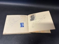 An autograph album containing a number of 1950s racing car drivers including Stirling Moss, Mike