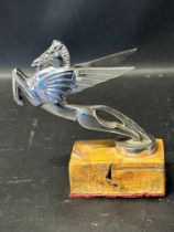 A circa 1930 Pegasus chrome plated car accessory mascot, wooden block base mounted.