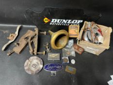 A box of motoring memorabilia including a Lagonda car badge, rally ashtray, Dunlop Motorcycles sign,