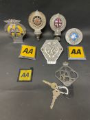 A tray of mixed RAC and AA badges including commercial.