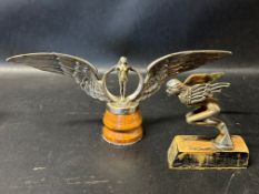 Two circa 1920s car accessory mascots: an Egyptian nymph and a nymph in a winged circle, stamped
