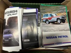 A significant volume of mostly 1980s vehicle brochures.