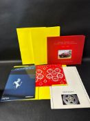Four Ferrari brochures and a related Ferrari book. Three brochures cover F355 Berlinetta and the