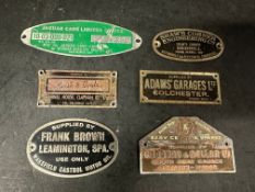 Six garage supplier plates, plaques, badges, emblems.