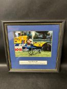 A framed and glazed photograph of Nigel Mansell, signed by the racing driver himself - 1992 FIA