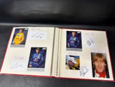 A substantial autograph album containing photographs and signatures of famous racing drivers of Le