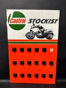 A Castrol motorcycle accessories point of sale card with attached hooks.