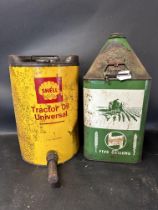 Two agricultural tractor oil five gallon cans: Agricastrol and Shell Tractor Oil Universal.