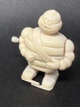 A Michelin Mr. Bibendum wind-up figure.