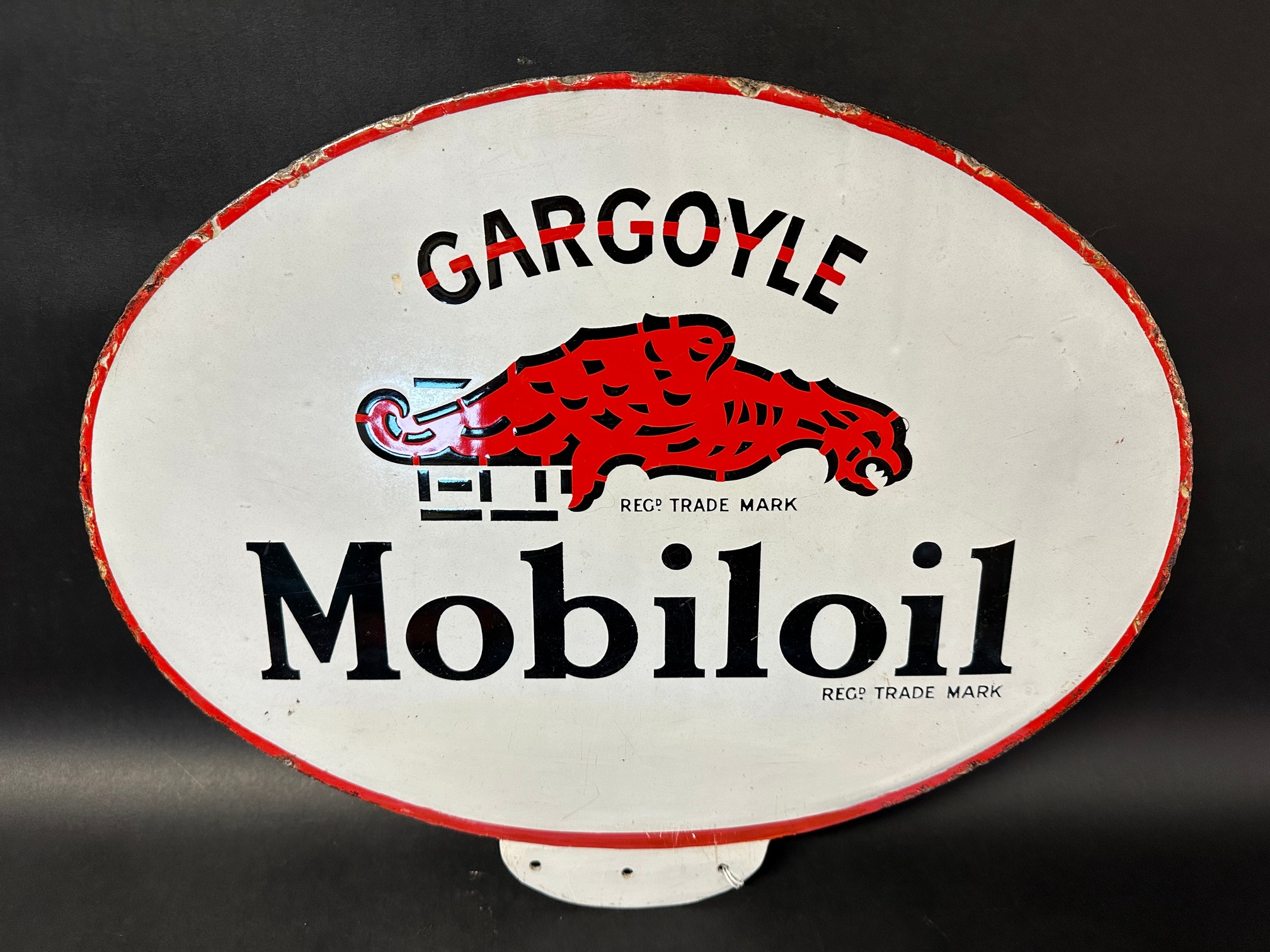 A Gargoyle Mobiloil double sided enamel advertising sign from the top of a forecourt cabinet.